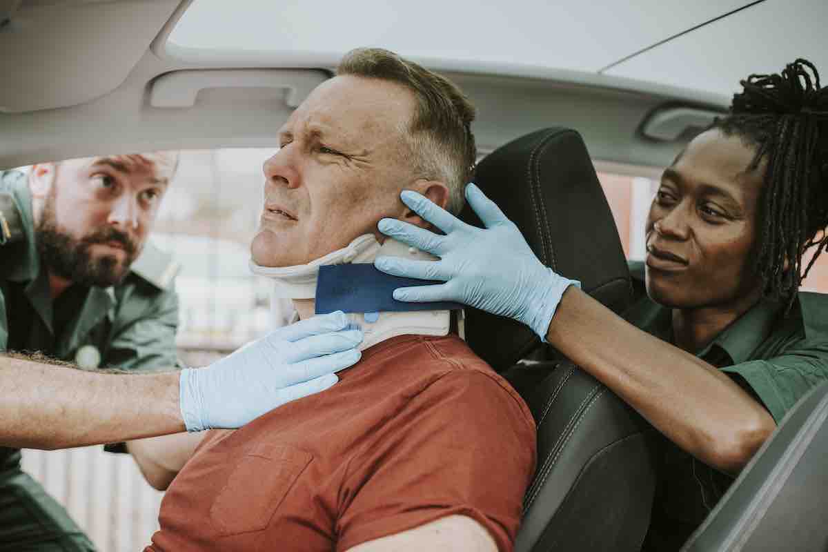 Paramedic helping car accident victim in Florida